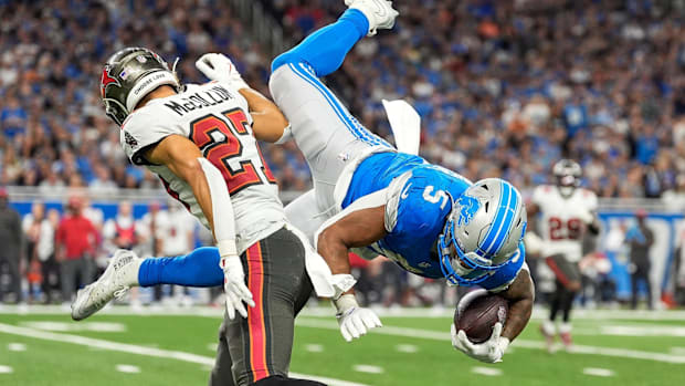 Detroit Lions running back David Montgomery jumps over Tampa Bay Buccaneers cornerback Zyon McCollum. 
