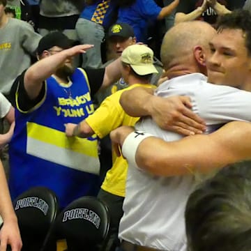 Barlow coach Tom Johnson and senior guard Jalen Atkins hug after the Bruins won the OSAA Class 6A boys basketball state championship Saturday night.
