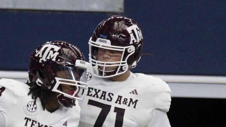 Sep 30, 2023; Arlington, Texas, USA; Texas A&M Aggies running back Earnest Crownover (24) and offensive lineman Chase Bisontis (71) celebrate after Crownover scores a touchdown against the Arkansas Razorbacks during the first half at AT&T Stadium. Mandatory Credit: Jerome Miron-Imagn Images