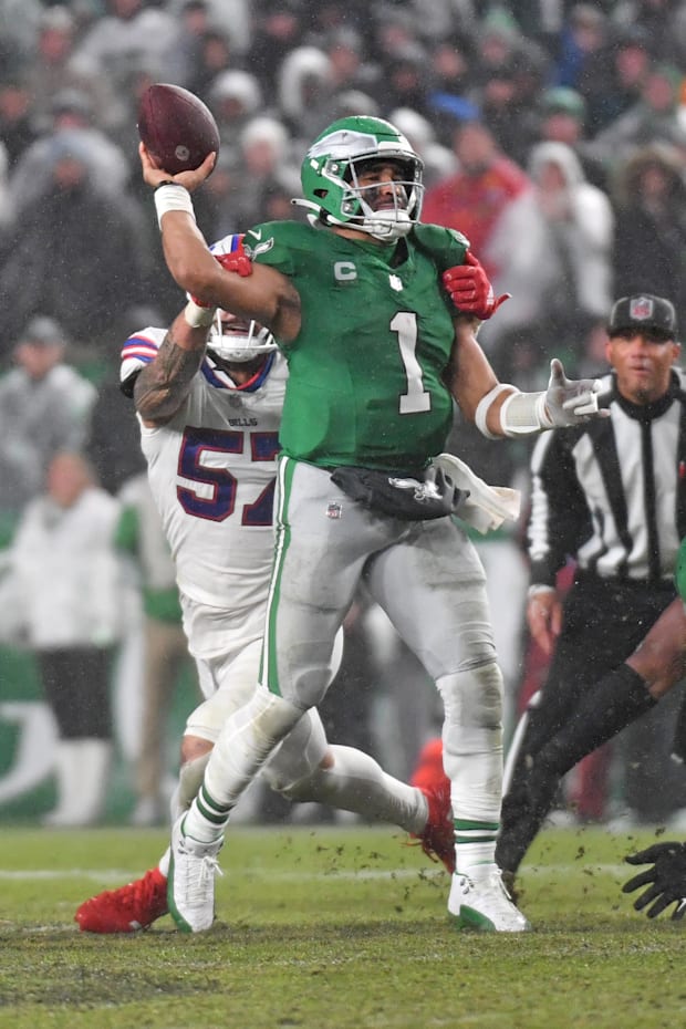 Philadelphia Eagles quarterback Jalen Hurts throws under pressure from Buffalo Bills defensive end AJ Epenesa