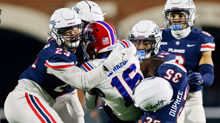 TJ Bush Jr. (23) makes a tackle for Liberty