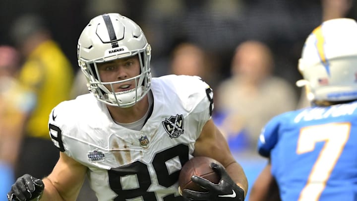 Sep 8, 2024; Inglewood, California, USA; Las Vegas Raiders tight end Brock Bowers (89) runs for a first down before he is stopped by Los Angeles Chargers cornerback Kristian Fulton (7) in the first half at SoFi Stadium. Mandatory Credit: Jayne Kamin-Oncea-Imagn Images