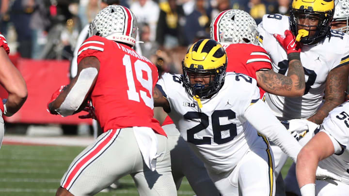 Michigan defensive lineman Rayshaun Benny (26) tackles Ohio State running back Chip Trayanum during the first half at Ohio Stadium in Columbus on Nov. 26, 2022.

Michohio 112622 Kd 3578