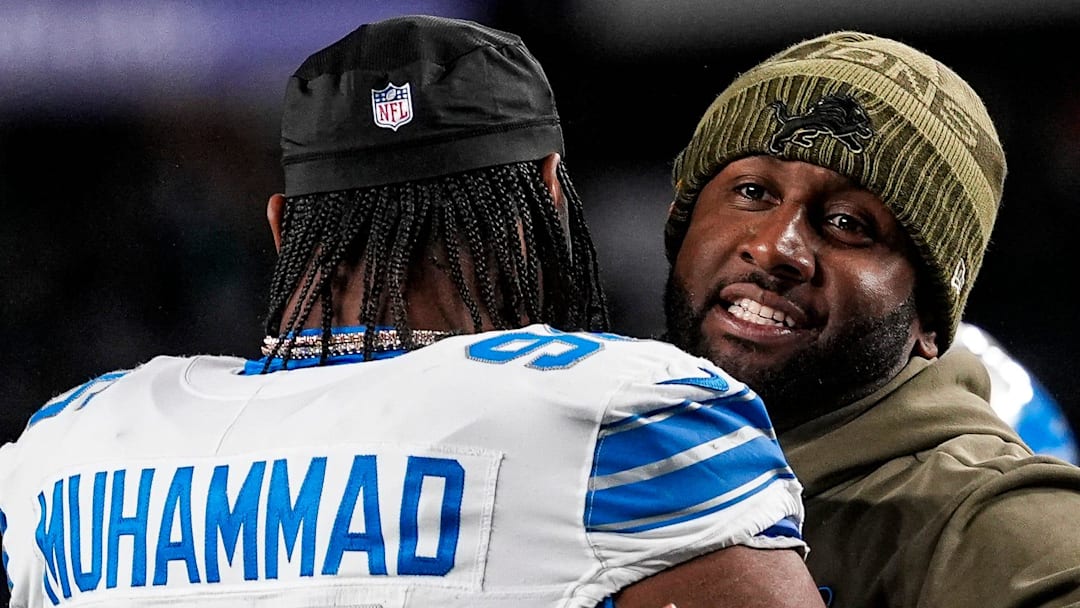 Detroit Lions defensive coordinator Kelvin Sheppard hugs linebacker Al-Quadin Muhammad (96) 