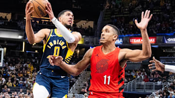 Nov 27, 2023; Indianapolis, Indiana, USA; Indiana Pacers guard Tyrese Haliburton (0) shoots the ball while Portland Trail Blazers guard Malcolm Brogdon (11)  defends in the second half at Gainbridge Fieldhouse. Mandatory Credit: Trevor Ruszkowski-Imagn Images