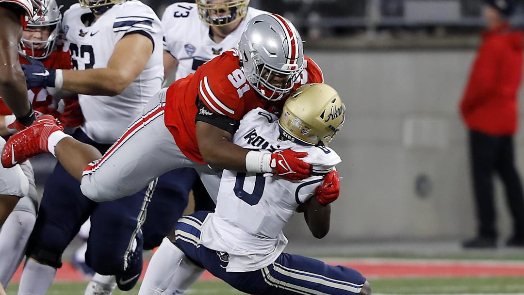 Sep 25, 2021; Columbus, Ohio, USA; Ohio State Buckeyes defensive tackle Tyleik Williams (91)with the sack of Akron Zips quarterback DJ Irons (0) during the fourth quarter at Ohio Stadium. Mandatory Credit: Joseph Maiorana-USA TODAY Sports