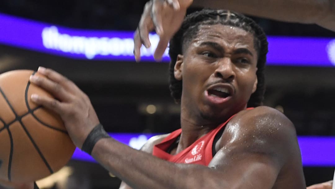 Toronto Raptors forward center Collin Murray-Boyles gets a rebound from Charlotte Hornets guard Sion James.