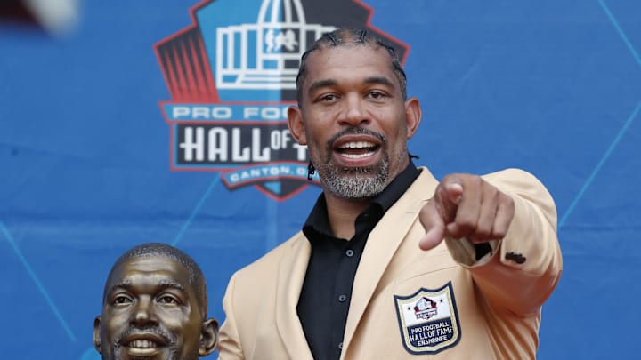 Aug 3, 2024; Canton, OH, USA; Class of 2024 member Julius Peppers poses with his bust at the enshrinement ceremony at Tom Benson Hall of Fame Stadium.