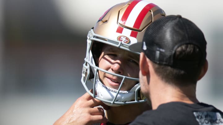 Jul 26, 2024; Santa Clara, CA, USA; San Francisco 49ers quarterback Brock Purdy (13) talks with a coach during Day 4 of training camp at SAP Performance Facility. Mandatory Credit: D. Ross Cameron-USA TODAY Sports