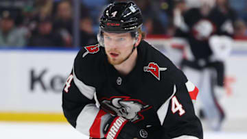 Apr 8, 2025; Buffalo, New York, USA;  Buffalo Sabres defenseman Bowen Byram (4) looks to make a pass during the second period against the Carolina Hurricanes at KeyBank Center. Mandatory Credit: Timothy T. Ludwig-Imagn Images