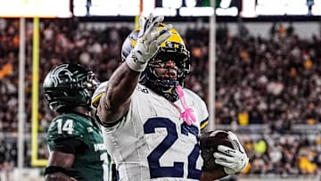 Michigan running back Justice Haynes (22) runs for a touchdown against Michigan State defensive back Malcolm Bell (14) during the second half at Spartan Stadium in East Lansing on Saturday, October 25, 2025.