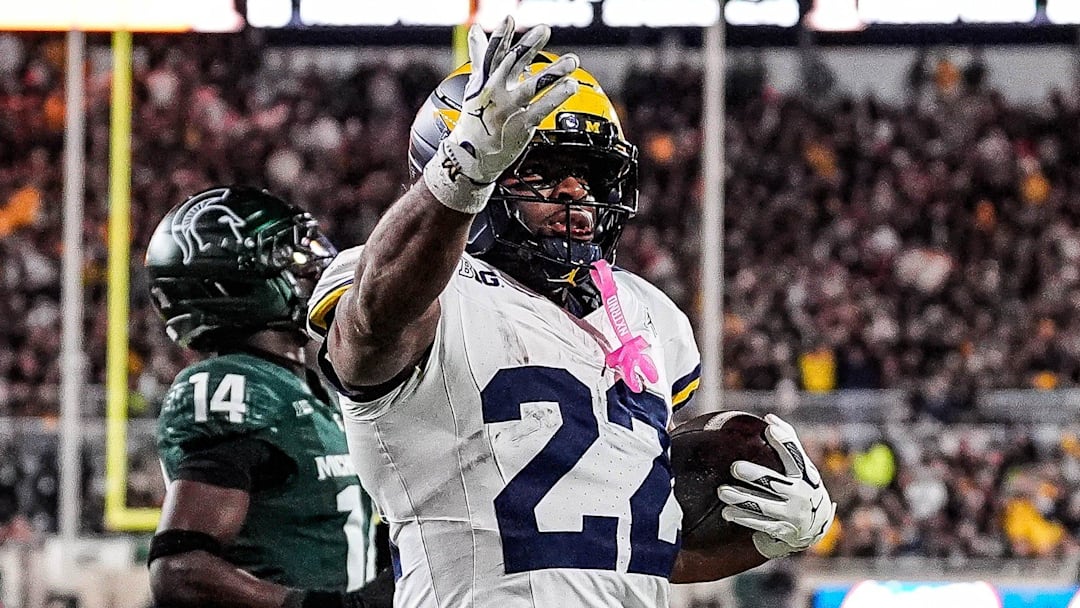 Michigan running back Justice Haynes (22) runs for a touchdown against Michigan State defensive back Malcolm Bell (14) during the second half at Spartan Stadium in East Lansing on Saturday, October 25, 2025.