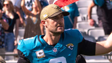 Jacksonville Jaguars punter Logan Cooke (9) enter the field with an American Flag during Salute to Service before the start of an NFL football game at EverBank Stadium, Sunday, November 16, 2025.