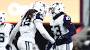 Dallas Cowboys outside linebacker Jadeveon Clowney and defensive end James Houston celebrate after a sack.