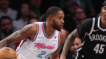Feb 7, 2025; Brooklyn, New York, USA; Miami Heat forward Haywood Highsmith (24) dribbles as Brooklyn Nets guard Keon Johnson (45) defends during the first quarter at Barclays Center. Mandatory Credit: Vincent Carchietta-Imagn Images