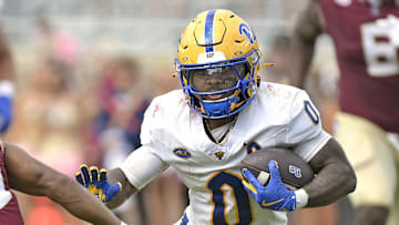 Oct 11, 2025; Tallahassee, Florida, USA; Pittsburgh Panthers running back Desmond Reid (0) runs the ball past Florida State Seminoles defensive back Jerry Wilson (19) during the second half at Doak S. Campbell Stadium. Mandatory Credit: Melina Myers-Imagn Images