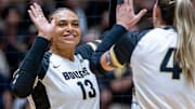 Purdue Senior Akasha Anderson (13) high-fives teammates after a point 