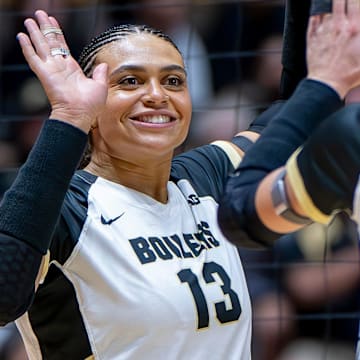Purdue Senior Akasha Anderson (13) high-fives teammates after a point 