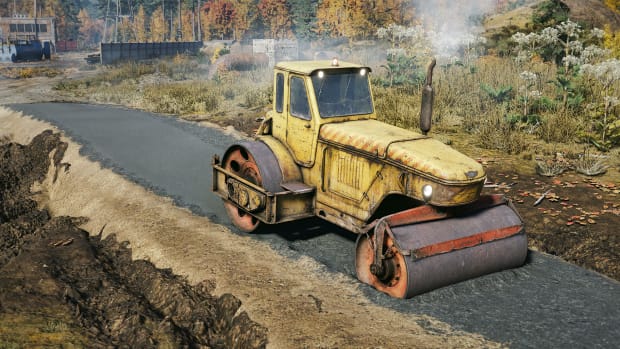 A roller compacting the first layer of asphalt for a new road.