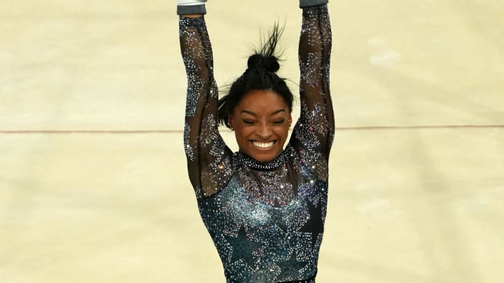 Jul 28, 2024; Paris, France; Simone Biles of the United States performs on the uneven bars in womenís qualification during the Paris 2024 Olympic Summer Games at Bercy Arena. \