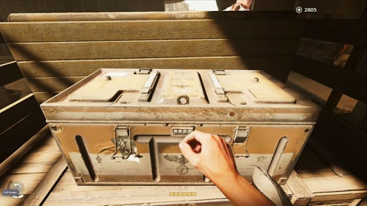 A chest in the back of a truck in a garage.