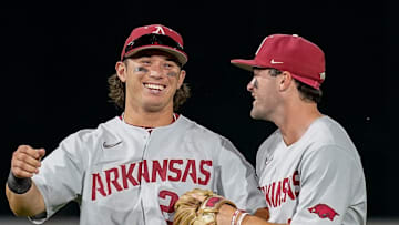 Arkansas second baseman Peyton Holt (24) and shortstop John Bolton (9) reacts after defeating Vanderbilt at Hawkins Field in Nashville, Tenn., Thursday, May 18, 2023.