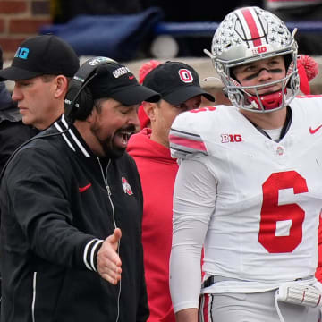 Nov 25, 2023; Ann Arbor, Michigan, USA; Ohio State Buckeyes head coach Ryan Day talks to quarterback Kyle McCord (6) on the sideline during the second half of the NCAA football game against the Michigan Wolverines at Michigan Stadium. Ohio State lost 30-24.