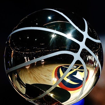 Oct 24, 2023; Denver, Colorado, USA; The Denver Nuggets logo is reflected in the Larry O Brien NBA Championship Trophy before the game against the Los Angeles Lakers at Ball Arena. Mandatory Credit: Isaiah J. Downing-USA TODAY Sports