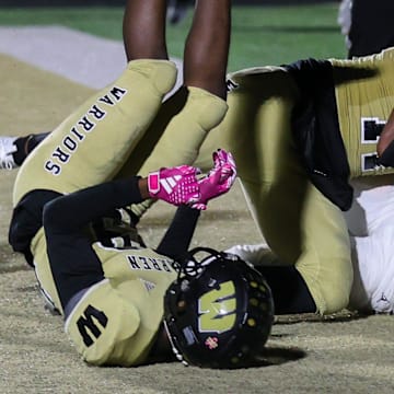 Cathedral Evan Johnson (88) attempts without success to break away the football from Warren Central Jerimy Finch Jr. (11