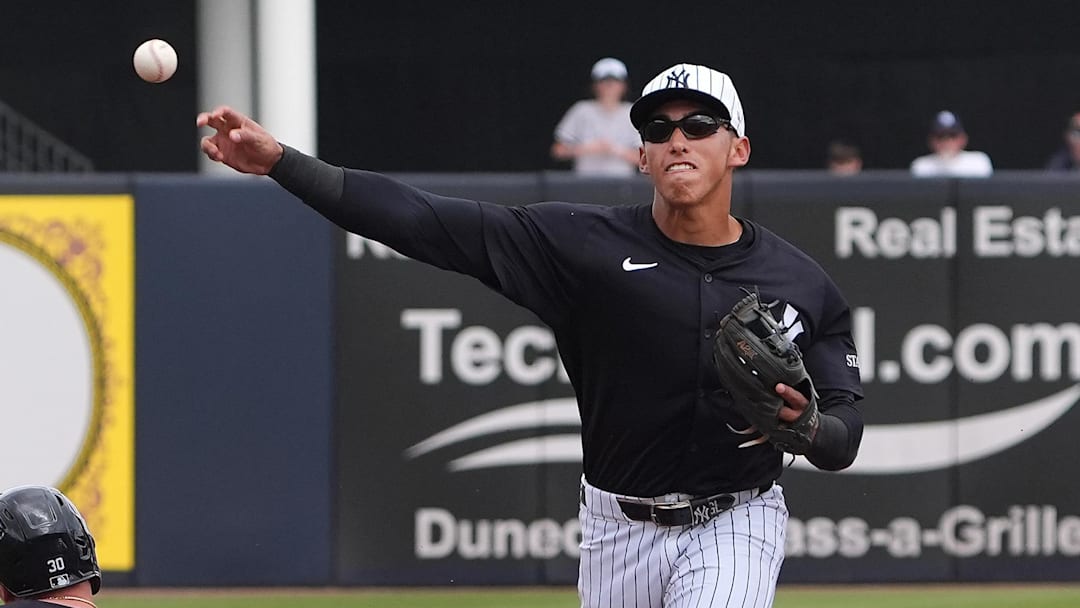 Mar 10, 2025; Tampa, Florida, USA; New York Yankees shortstop George Lombard Jr. (96) throws to first to make the double play as Detroit Tigers outfielder Kerry Carpenter (30) slides into second during the first inning at George M. Steinbrenner Field.