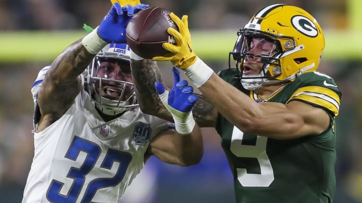 Sep 28, 2023; Green Bay, Wisconsin, USA; Detroit Lions safety Brian Branch (32) breaks up a pass intended for Green Bay Packers wide receiver Christian Watson (9) during their football game on Thursday, September 28, 2023, at Lambeau Field in Green Bay, Wis. Mandatory Credit: Tork Mason-USA TODAY Sports