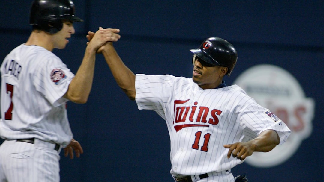 Minnesota Twins right fielder #11 Jacque Jones high-fives catcher #7 Joe Mauer after they each scored.  Mandatory Credit: Photo By Bruce Kluckhohn-Imagn Images Copyright (c) 2005 Bruce Kluckhohn