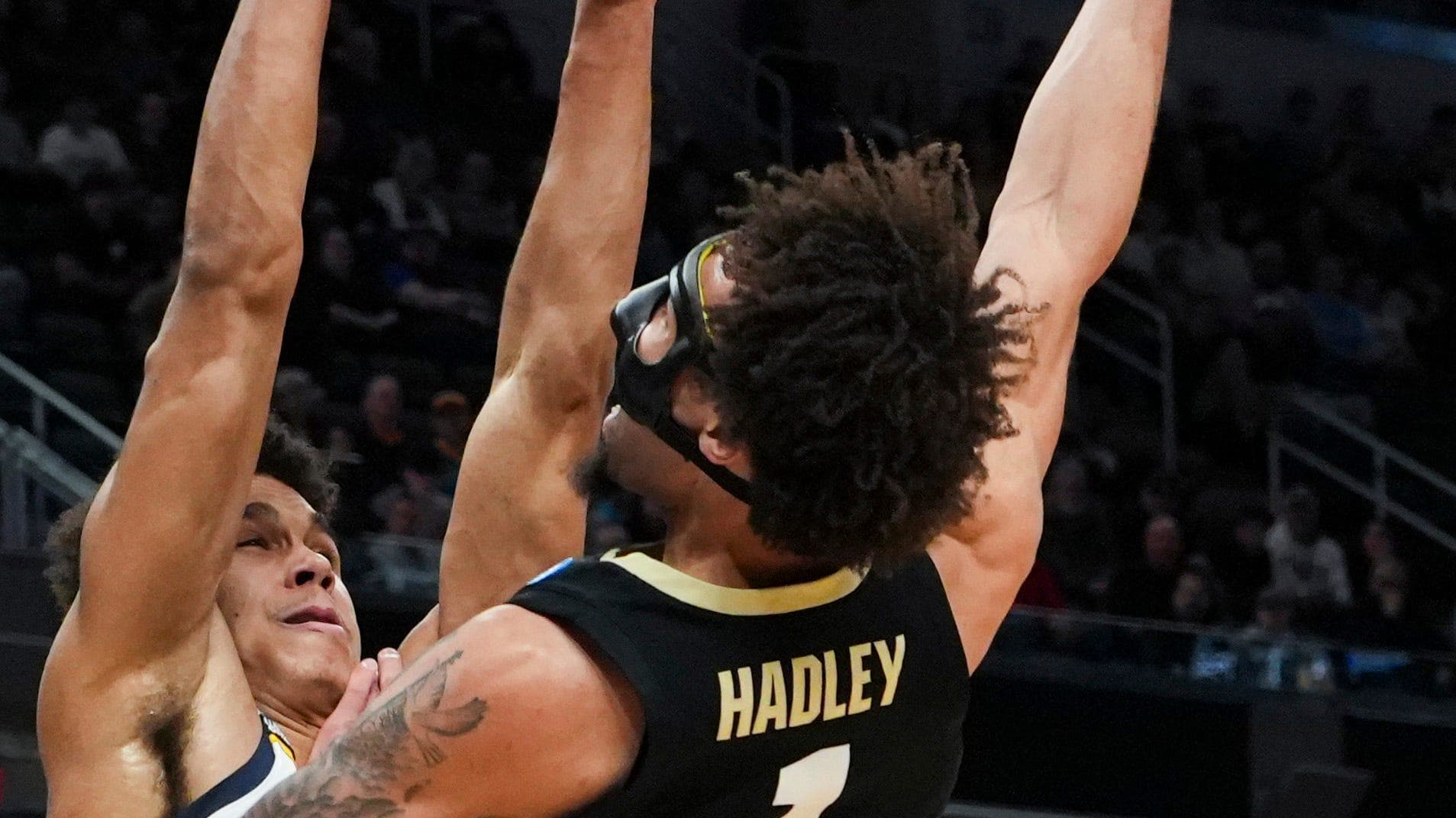 Colorado Buffaloes guard J'Vonne Hadley (1) lays the ball up against Marquette Golden Eagles forward