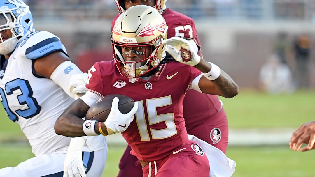 Nov 2, 2024; Tallahassee, Florida, USA;  Florida State Seminoes receiver Lawayne McCoy (15) runs the ball for a two point conversion against the North Carolina Tarheels in the first quarter at Doak S. Campbell Stadium. Mandatory Credit: Robert Myers-Imagn Images