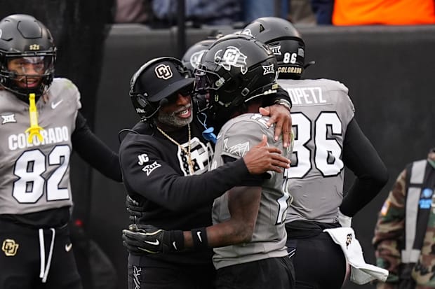 Nov 16, 2024; Boulder, Colorado, USA; Colorado head coach Deion Sanders hugs star Travis Hunter.
