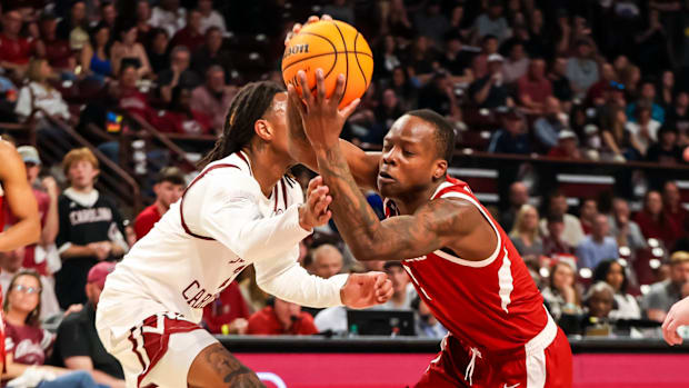 Razorbacks guard Johnell Davis (1) drives past South Carolina Gamecocks guard Zachary Davis (2)