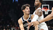 Oct 24, 2025; Brooklyn, New York, USA;  Brooklyn Nets guard Ben Saraf (77) is double teammed by Cleveland Cavaliers guard Donovan Mitchell (45) and center Jarrett Allen (31) in the first quarter at Barclays Center. Mandatory Credit: Wendell Cruz-Imagn Images