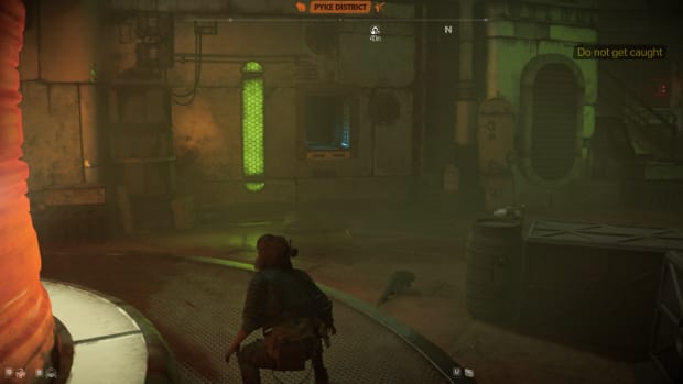 Star Wars Outlaws gameplay: Kay crouching in the Pyke's area, looking at an open vent in the wall.