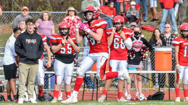 CVU's Alex Provost makes a nice catch along the sideline during the Redhawks' D1 football semifinal vs the Essex Hornets on S