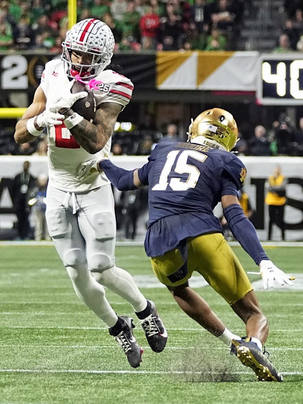 Ohio State Buckeyes wide receiver Emeka Egbuka makes a catch against Notre Dame Fighting Irish cornerback Leonard Moore. 