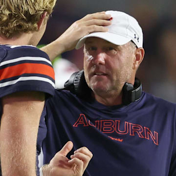 Auburn Tigers head coach Hugh Freeze talks with quarterback Hank Brown (15) during the fourth quarter against the New Mexico Lobos at Jordan-Hare Stadium.