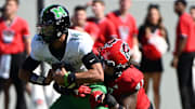 Marshall Thundering Herd quarterback Cam Fancher (14) is sacked by North Carolina State Wolfpack defensive lineman Jykeveous Red Hibbler (47) during the first half at Carter-Finley Stadium.