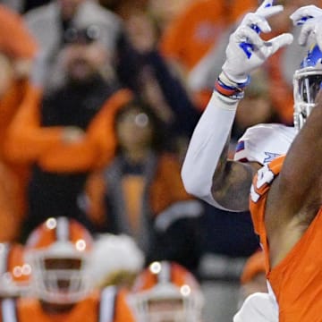 Sep 7, 2024; Champaign, Illinois, USA; Illinois Fighting Illini defensive back Xavier Scott (14) intercepts the ball in front of Kansas Jayhawks wide receiver Quentin Skinner (0) during the first half at Memorial Stadium. Mandatory Credit: Ron Johnson-Imagn Images