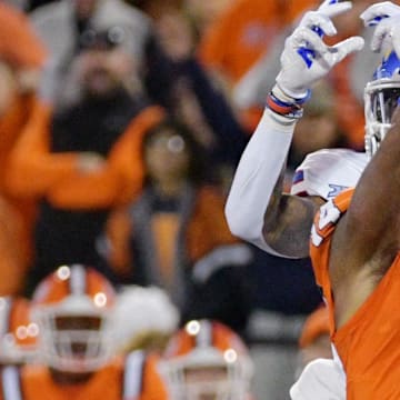 Sep 7, 2024; Champaign, Illinois, USA; Illinois Fighting Illini defensive back Xavier Scott (14) intercepts the ball in front of Kansas Jayhawks wide receiver Quentin Skinner (0) during the first half at Memorial Stadium. Mandatory Credit: Ron Johnson-Imagn Images