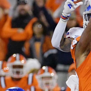 Sep 7, 2024; Champaign, Illinois, USA; Illinois Fighting Illini defensive back Xavier Scott (14) intercepts the ball in front of Kansas Jayhawks wide receiver Quentin Skinner (0) during the first half at Memorial Stadium. Mandatory Credit: Ron Johnson-Imagn Images