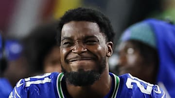 Seattle Seahawks cornerback Devon Witherspoon grimaces