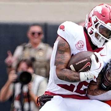 Oklahoma State's Nick Martin (4) tackles Arkansas' Ja'Quinden Jackson (22) first half against Oklahoma State at Boone Pickens Stadium in Stillwater, Okla.