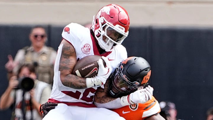 Oklahoma State's Nick Martin (4) tackles Arkansas' Ja'Quinden Jackson (22) first half against Oklahoma State at Boone Pickens Stadium in Stillwater, Okla.