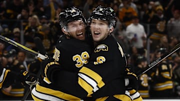 Oct 25, 2025; Boston, Massachusetts, USA; Boston Bruins center Morgan Geekie (39) is congratulated by defenseman Mason Lohrei (6) after scoring against the Colorado Avalanche during the second period at TD Garden. Mandatory Credit: Winslow Townson-Imagn Images