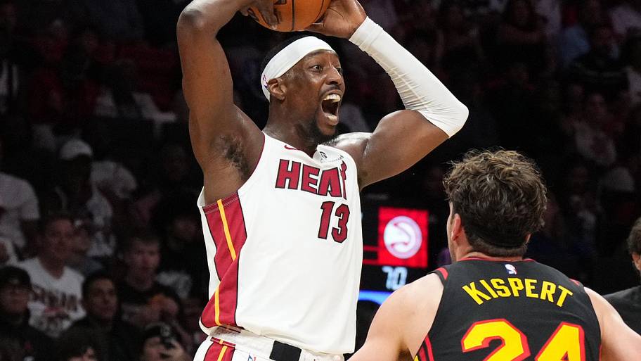 Miami Heat center Bam Adebayo looks to pass against Atlanta Hawks forward Corey Kispert.
